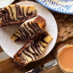 Zebra cake cut into slices on a plate.