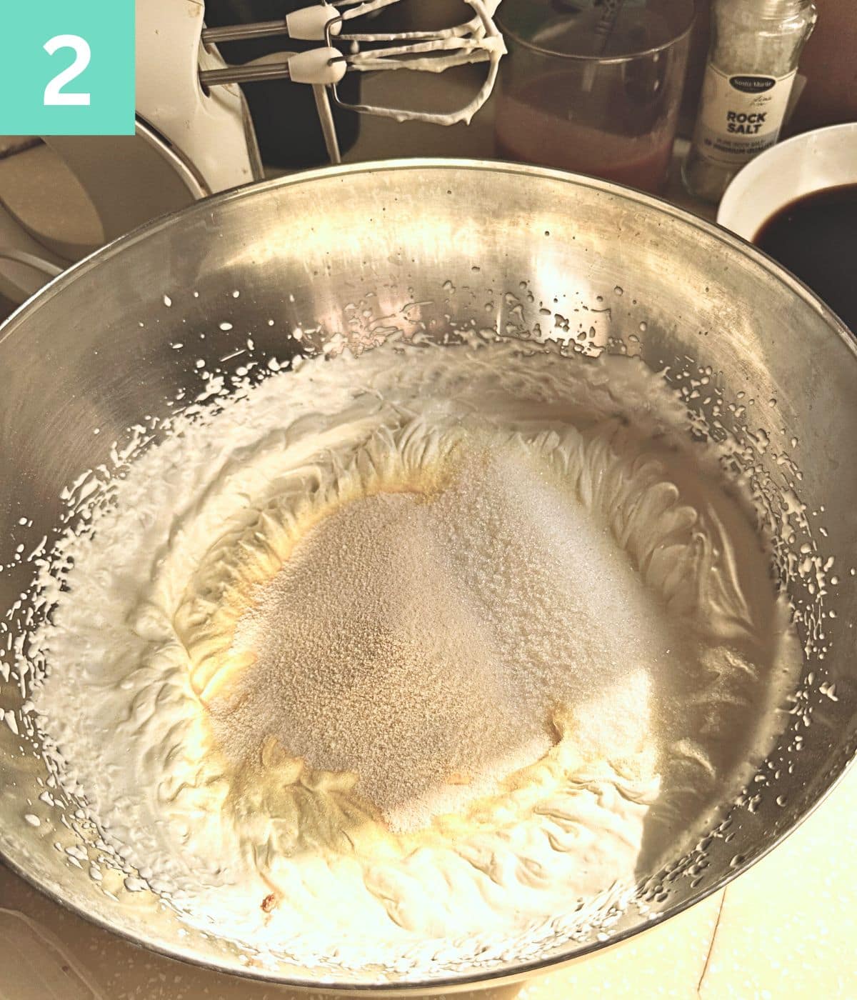 creme caramel mix added to whipped cream in a bowl.