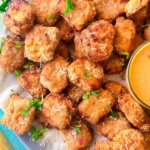 baked chili parmesan chicken nuggets served with sauce.