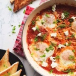 shaksuka eggs with bread.