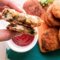 fried potato cakes with spinach and cheese with ketchup