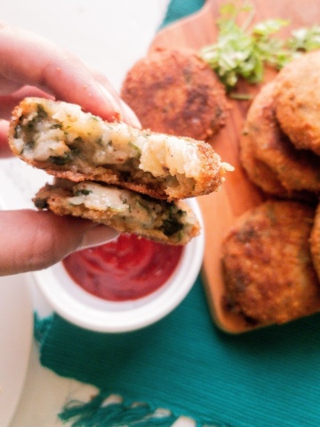 fried potato cakes with spinach and cheese with ketchup