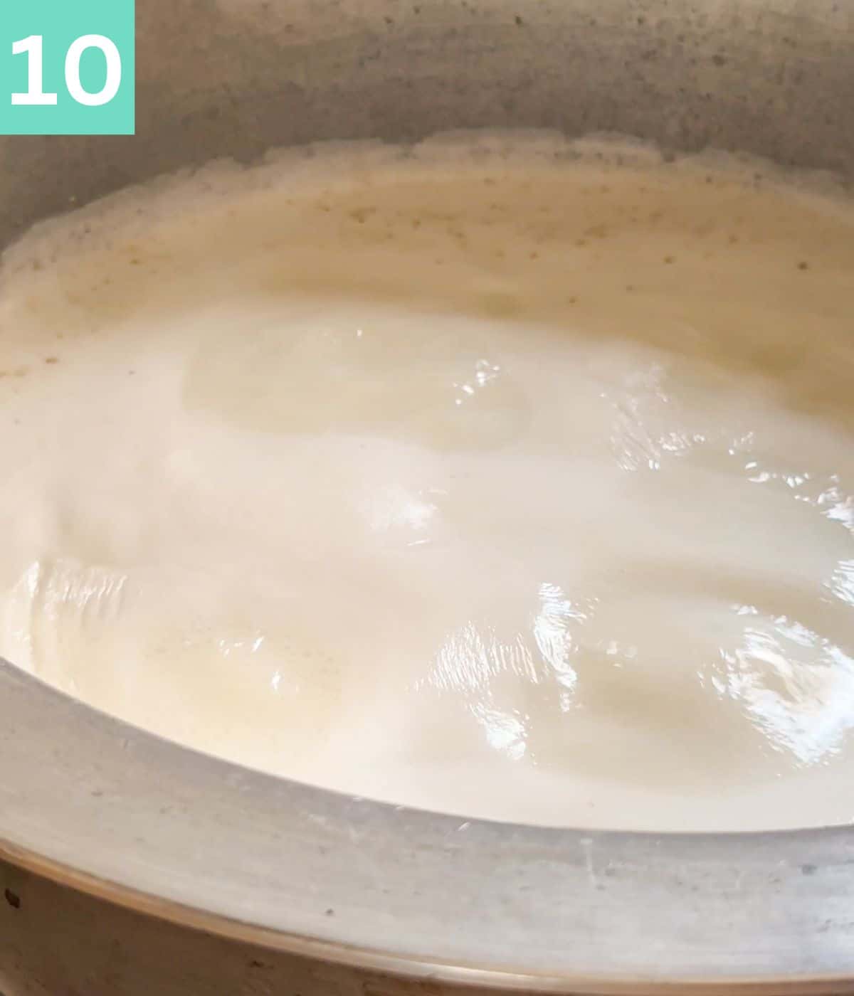simmering milk in a pot.