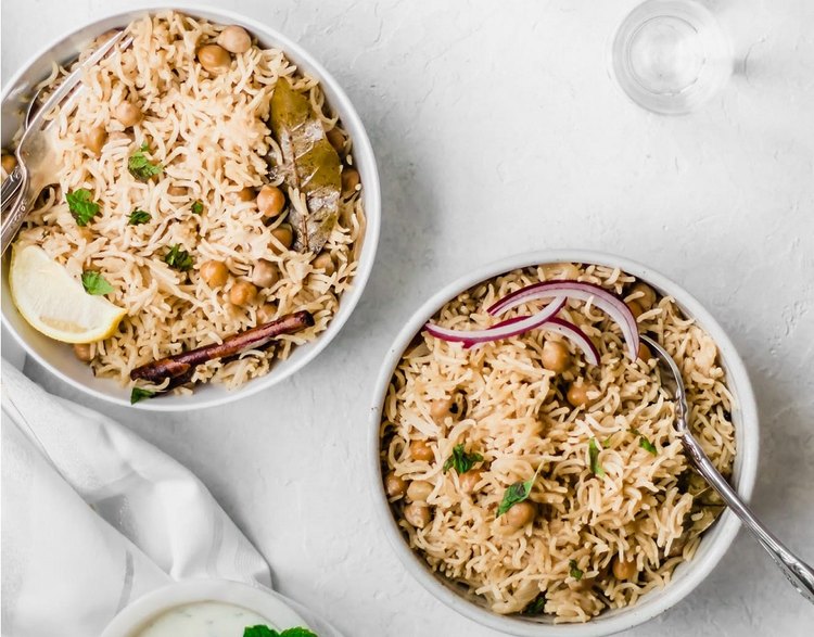 2 bowls of instant pot chana pulao on a white background