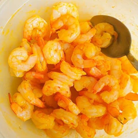 shrimps marinated in turmeric and salt for prawn masala