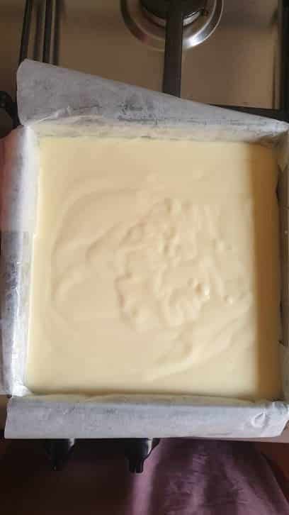 a square baking pan filled with custard 