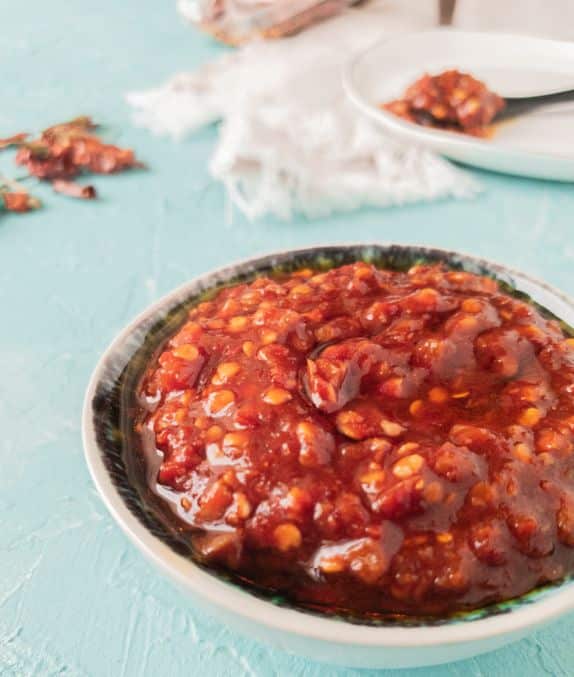 side view of red chili paste in a bowl