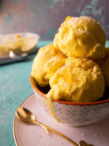 pineapple coconut ice cream scoops in a bowl