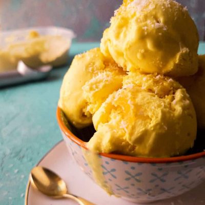 pineapple coconut ice cream scoops in a bowl