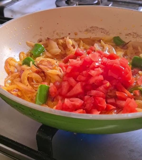 chopped tomatoes added to the spicy egg base