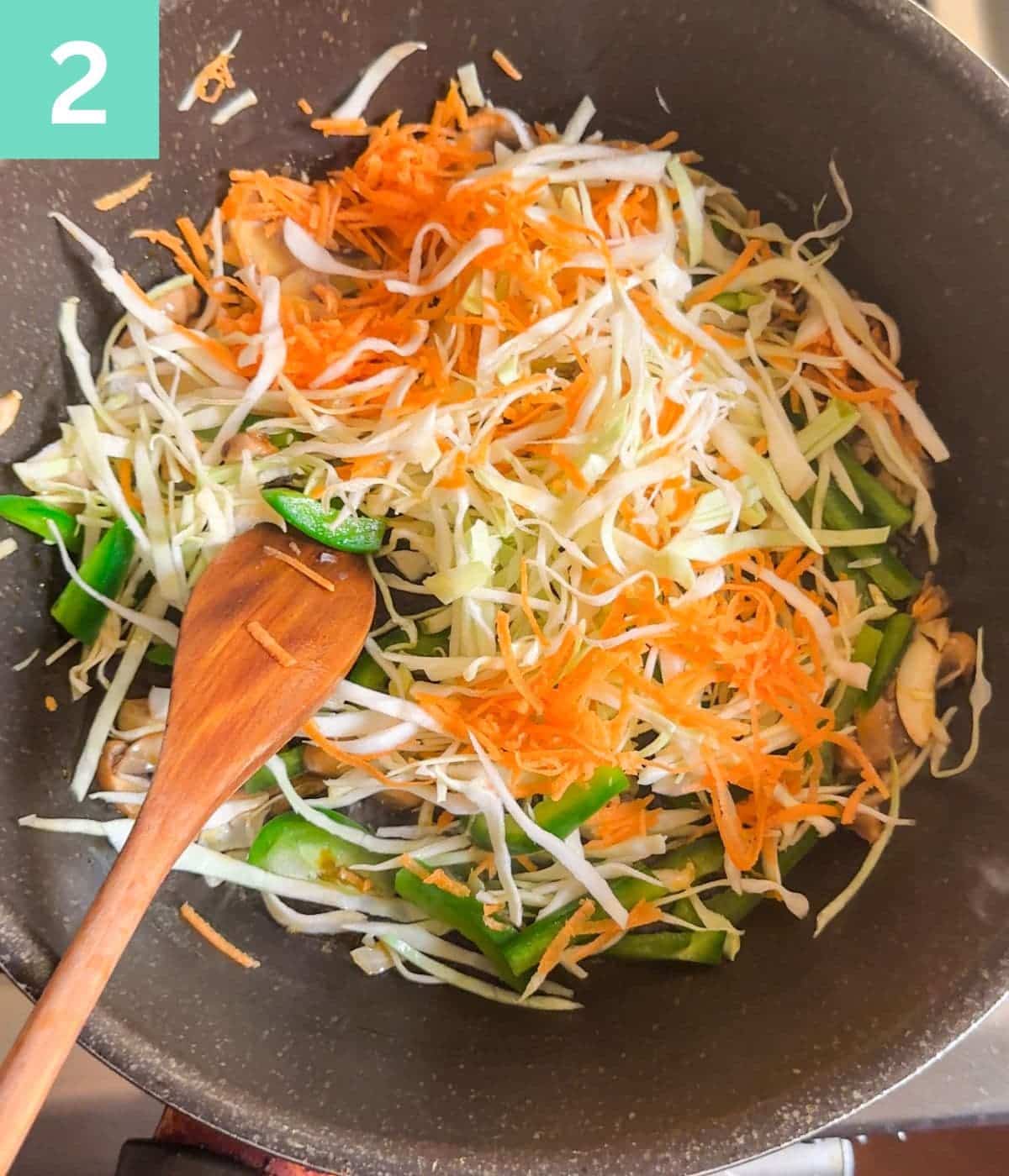 shredded and sliced vegetables added to mushrooms.