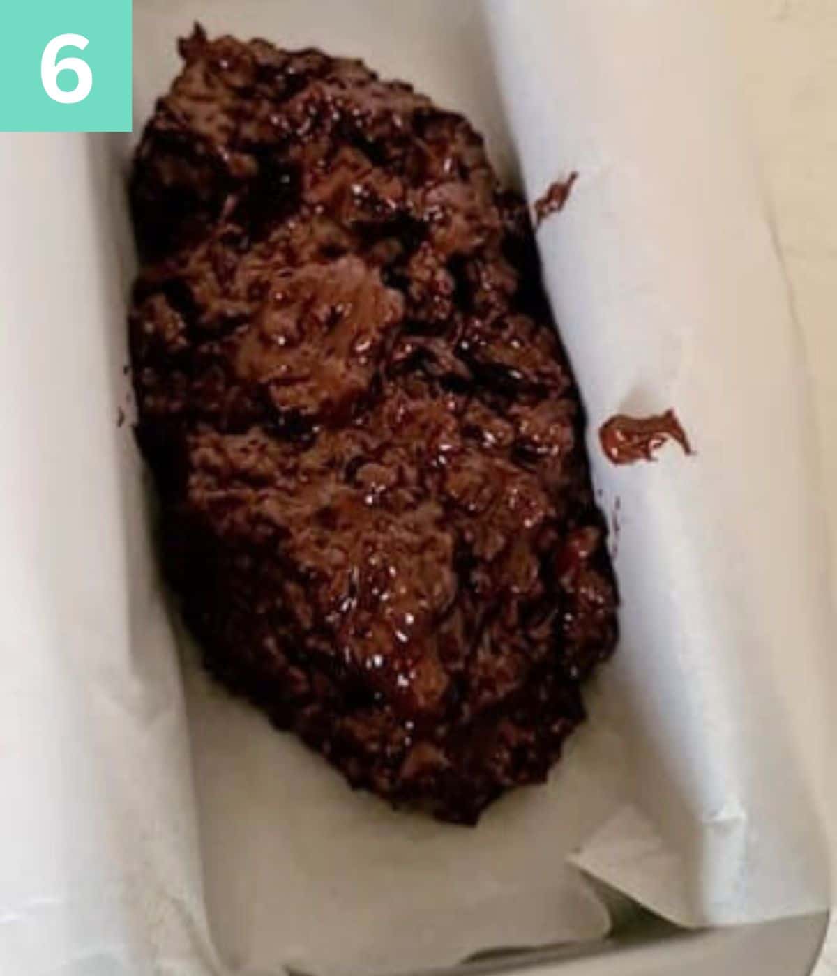 oatmeal bar mix poured into a lined loaf pan.