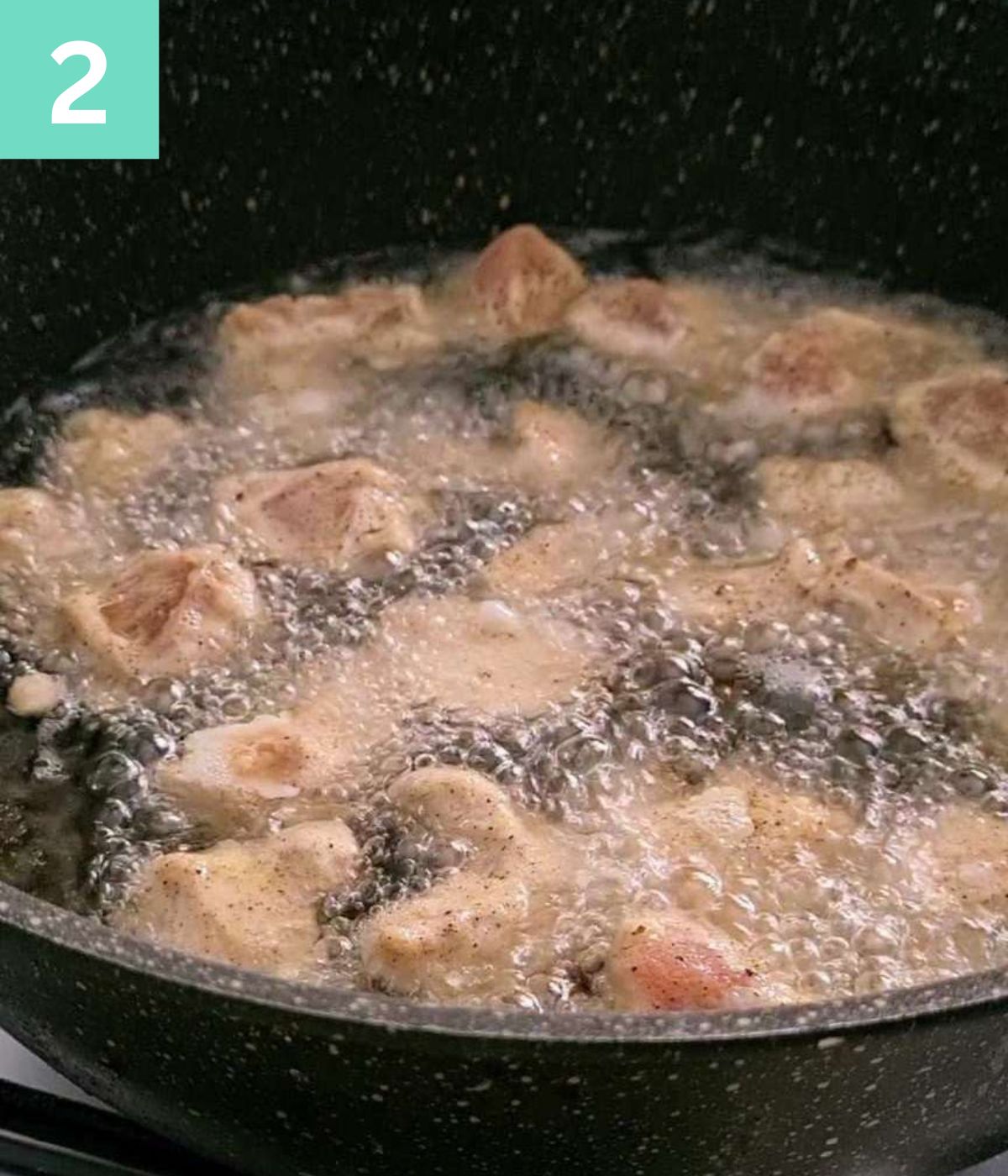 frying chicken pieces in oil.