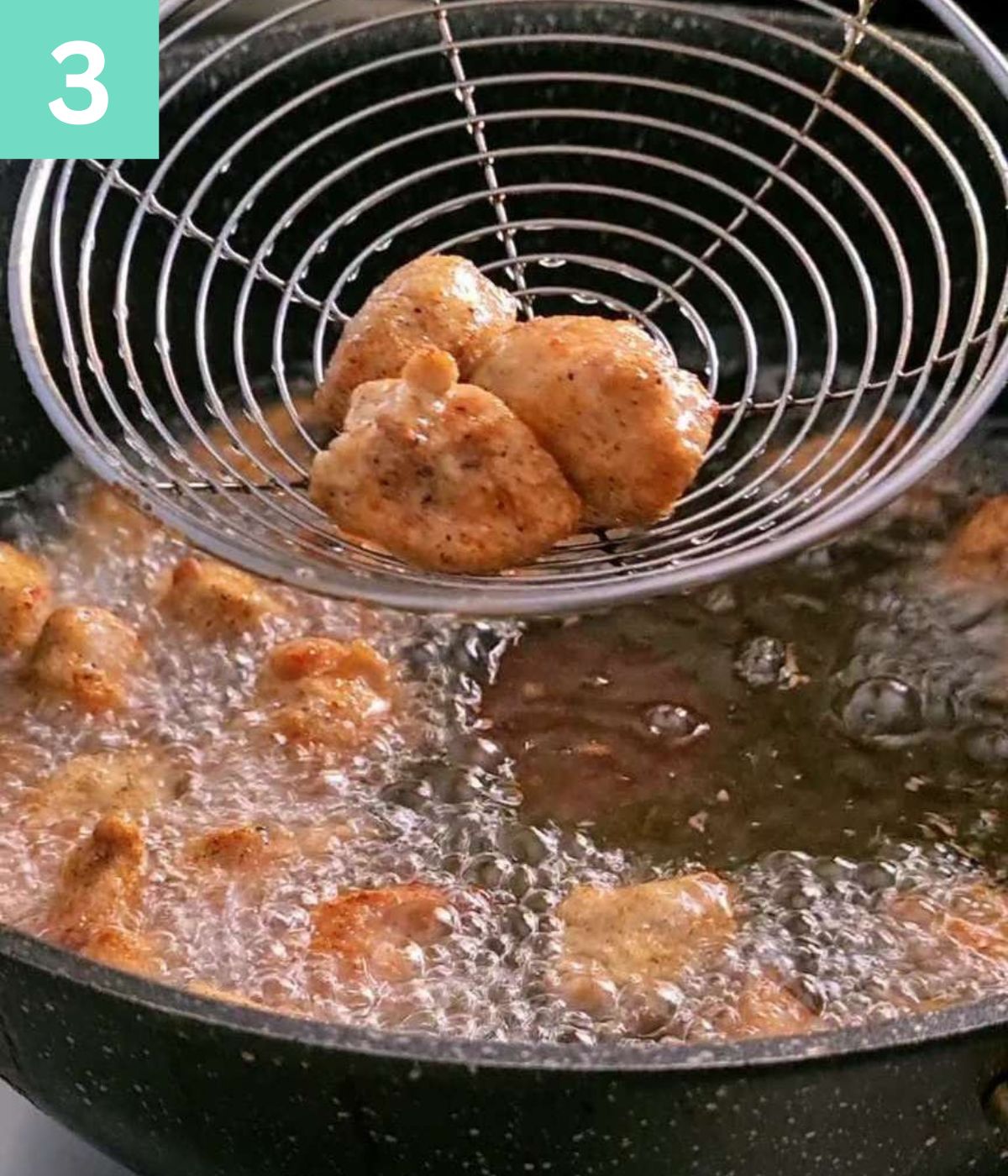 removing the fried chicken from oil.