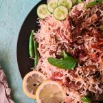 white mutton biryani made with goat meat in a black plate