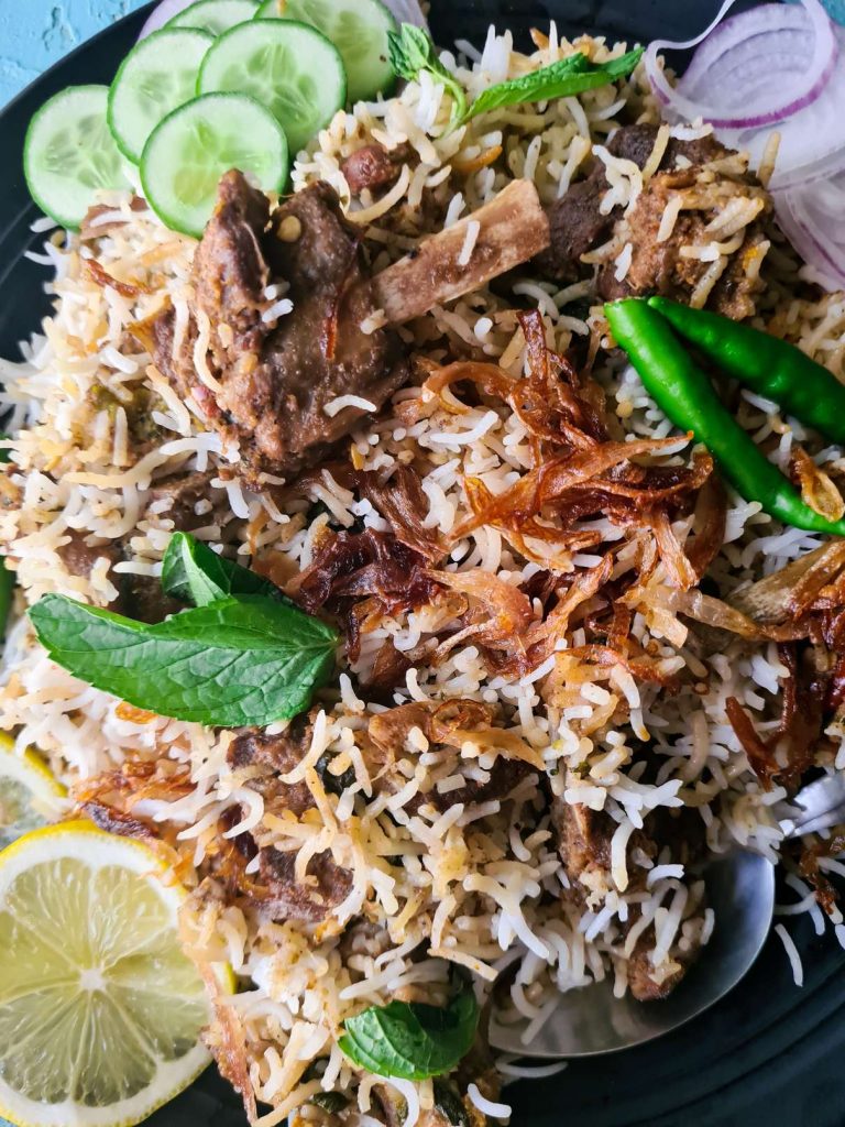 white mutton biryani made with goat meat in a black plate