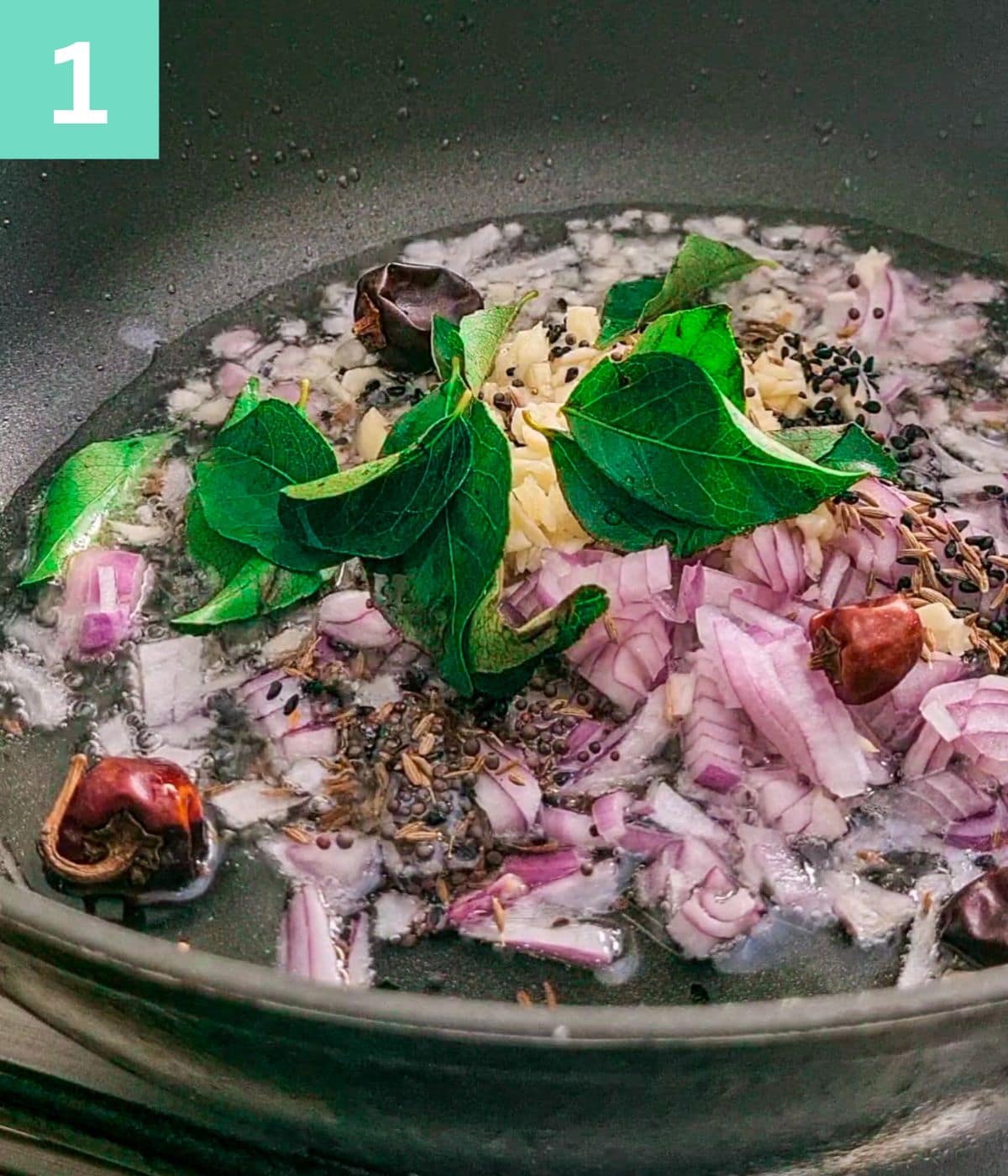 onions, whole spices, garlic and curry leaves in oil in pan.