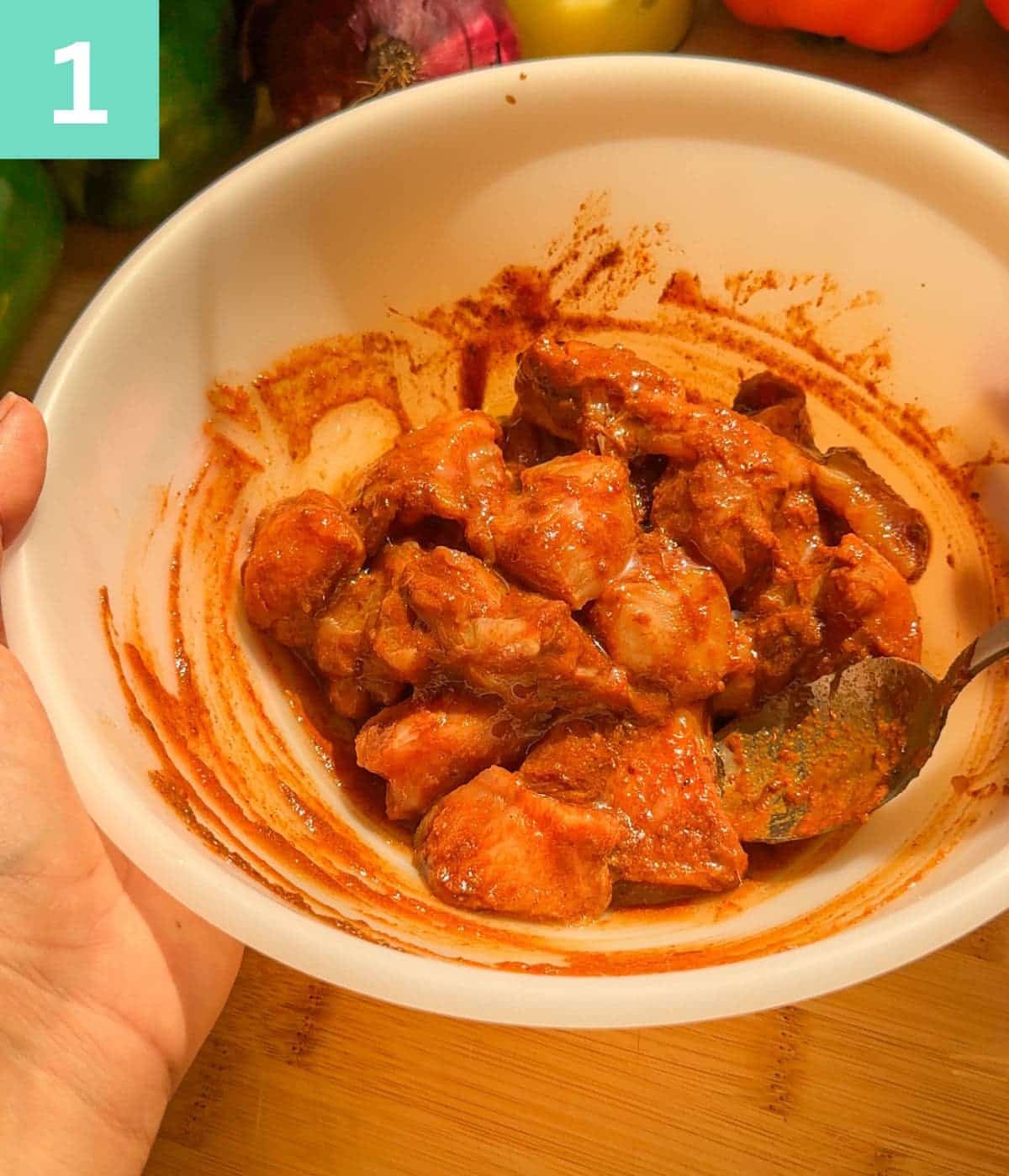 boneless chicken cubes marinated in a bowl.