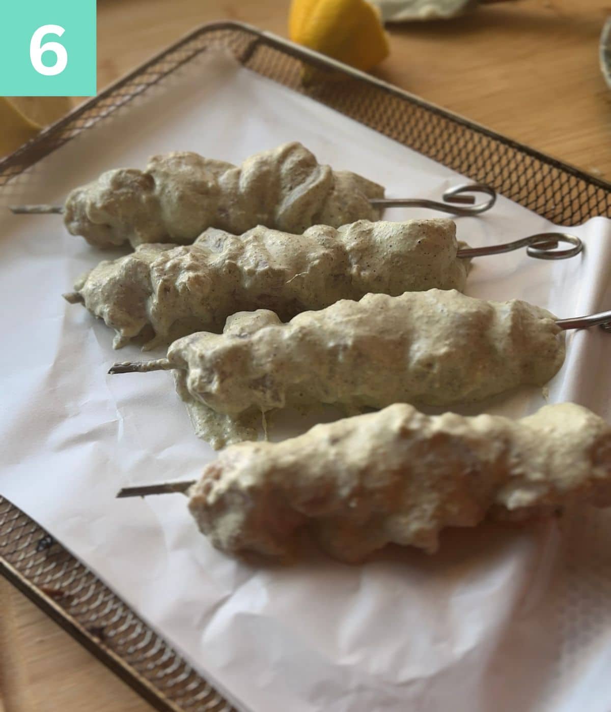 step 6: Malai boti threaded in skewers and on a baking tray.