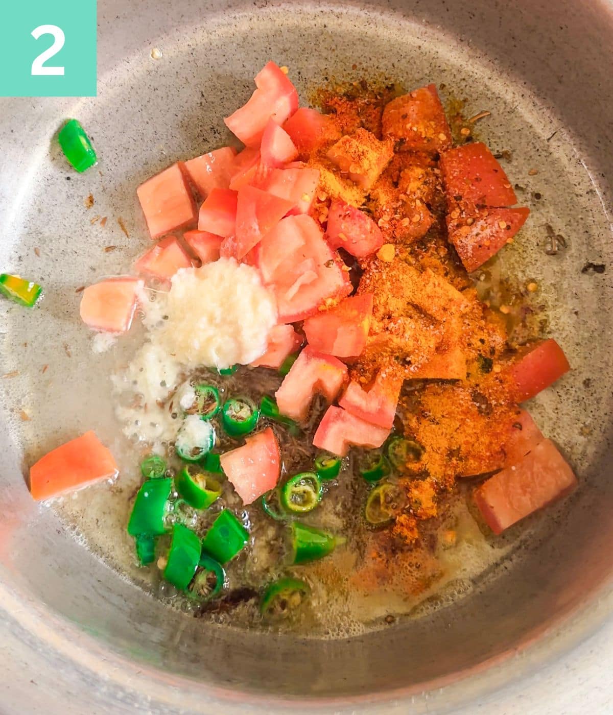 spices, tomato chunks added to pot.