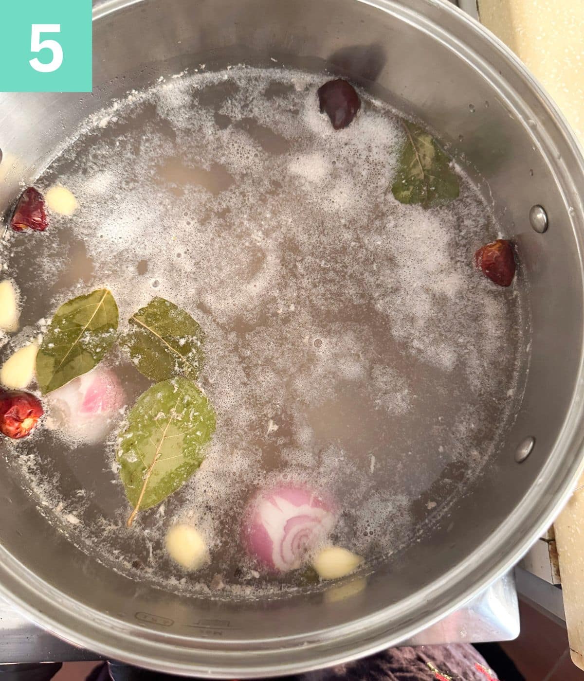 scum rises to surface of the chicken stock.