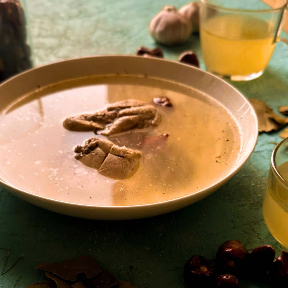 chicken broth with chicken served in a bowl.