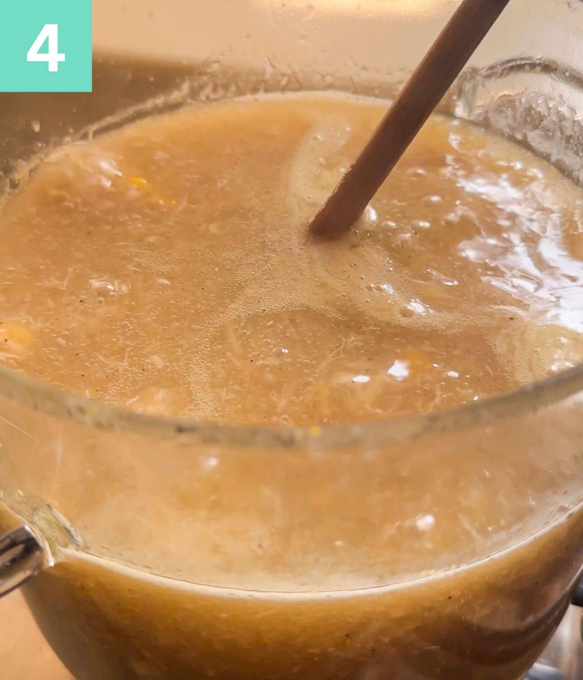 stirring a simmering broth with wooden spoon.