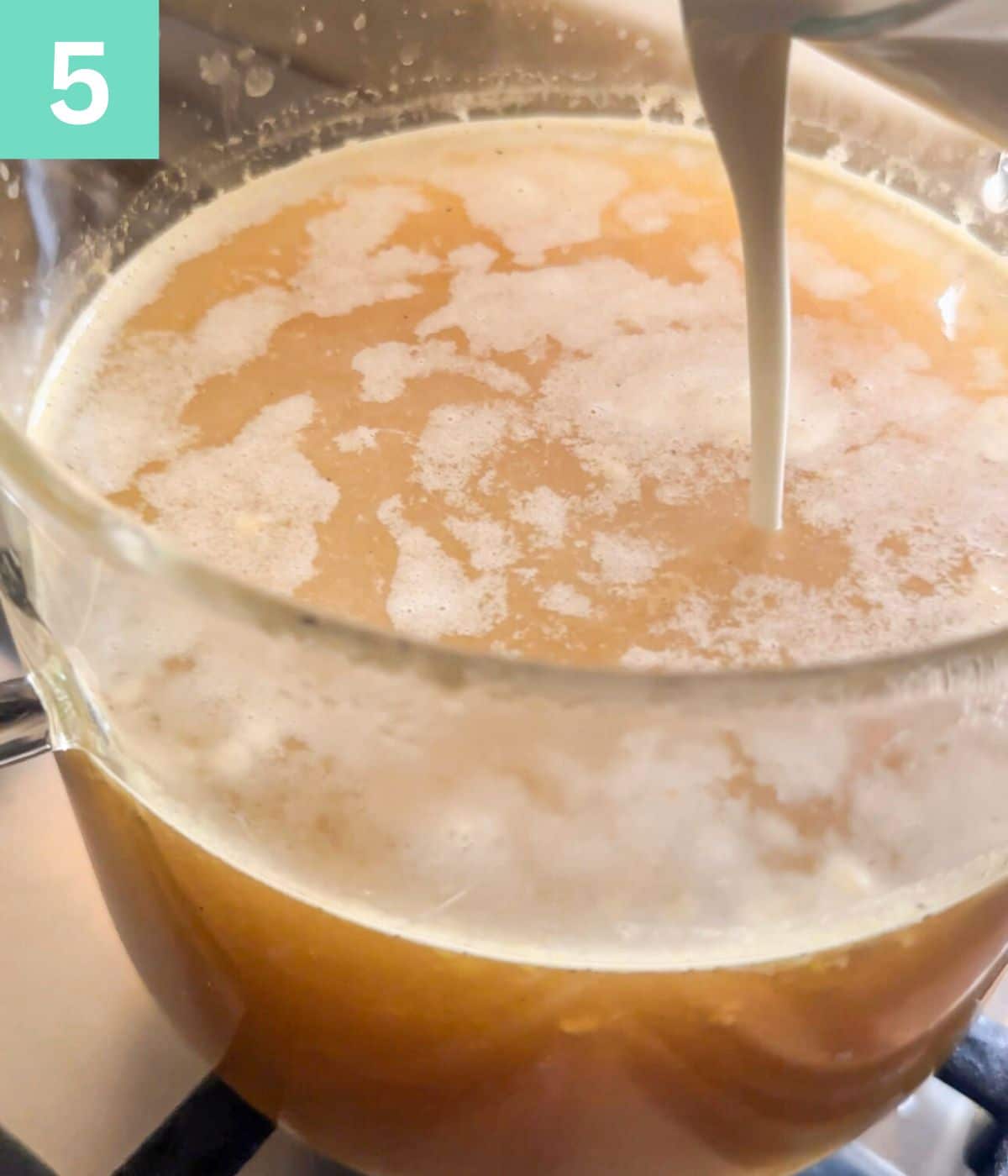 cornflour slurry being added to the broth.