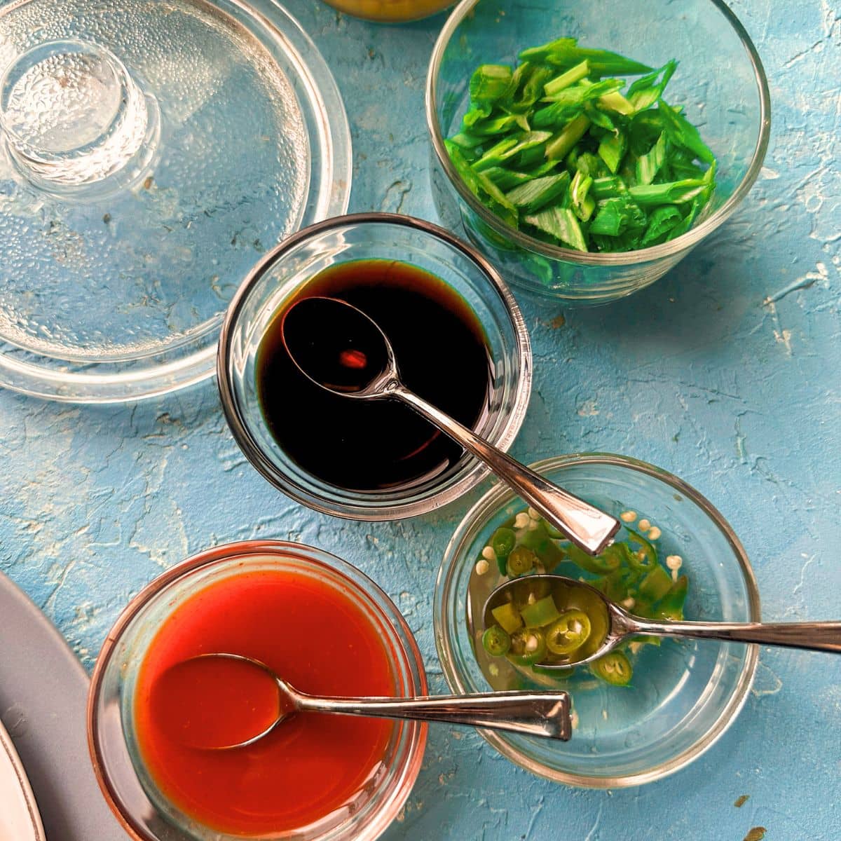 different condiments used for soup topping shown in separate bowls.