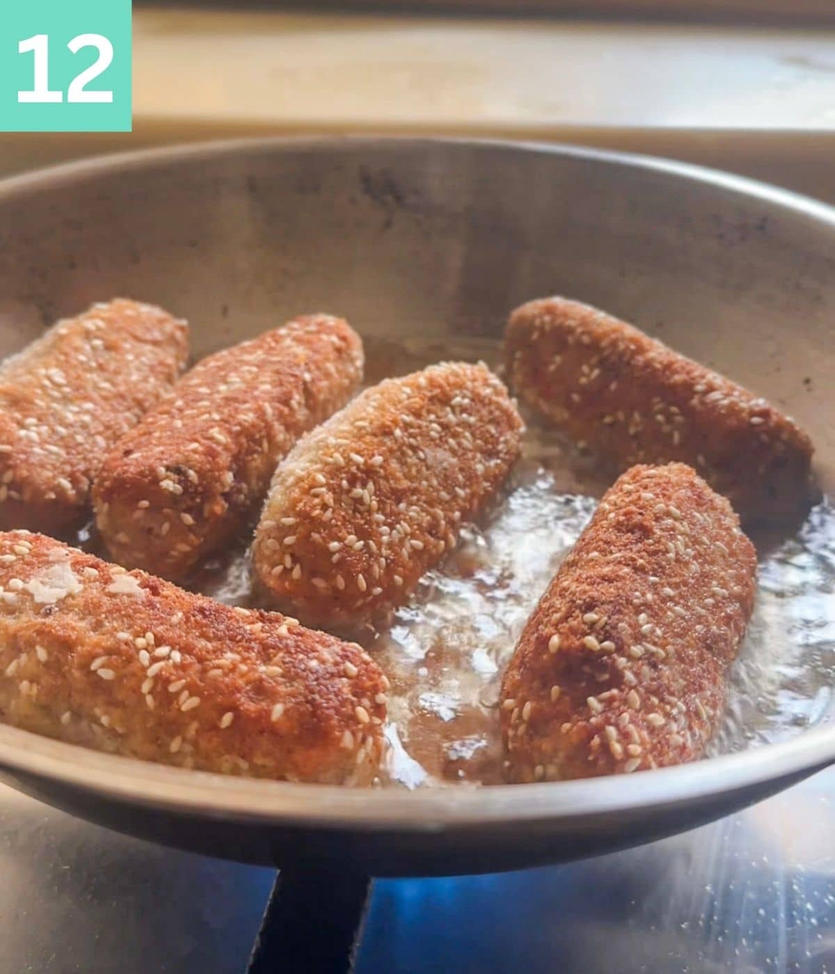 croquettes frying in oil and turning golden brown.