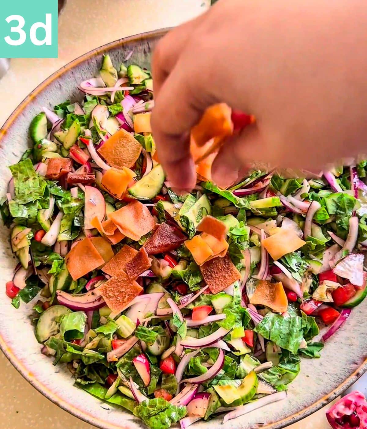 pita chips topped on the salad.