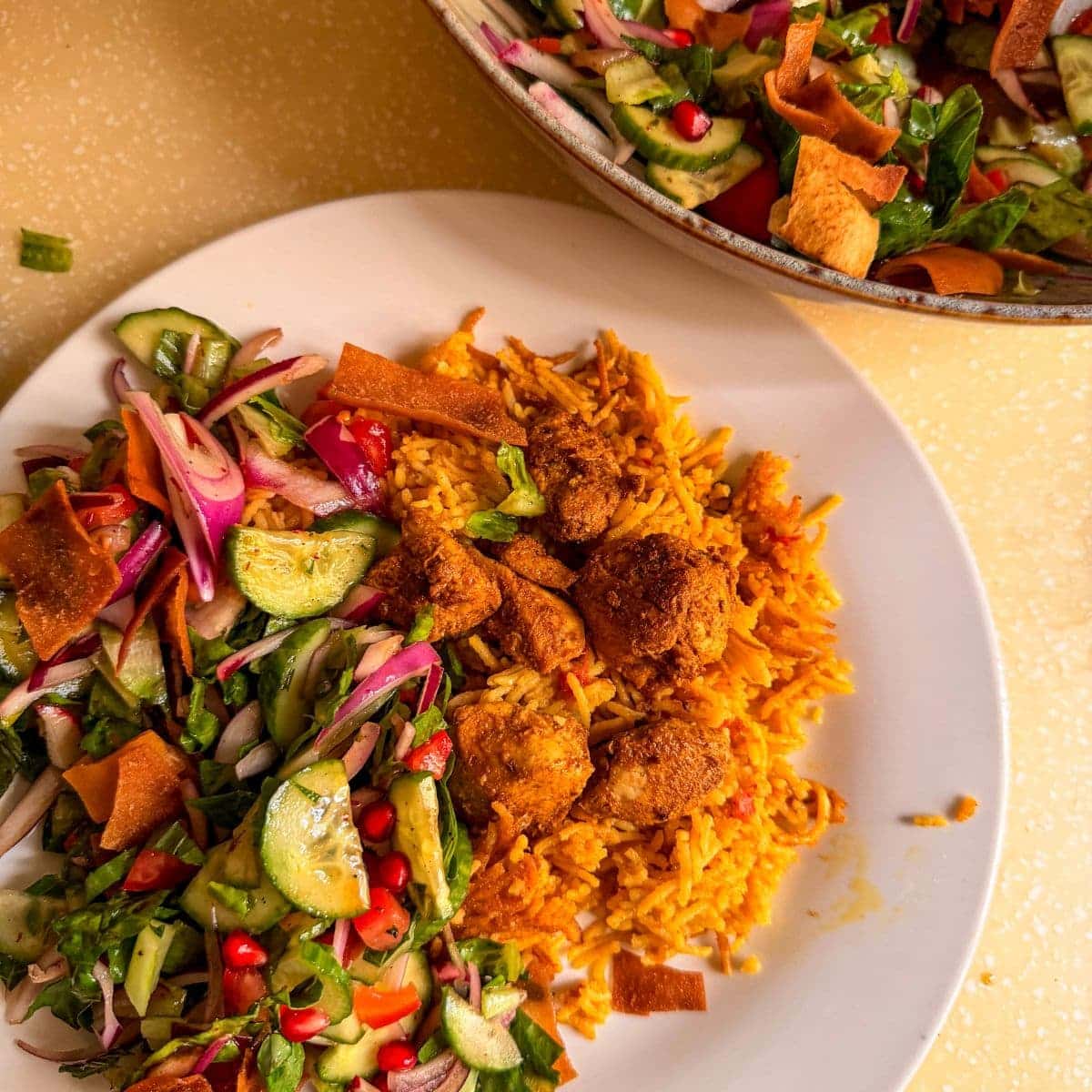 fattoush served with yellow rice and meat.