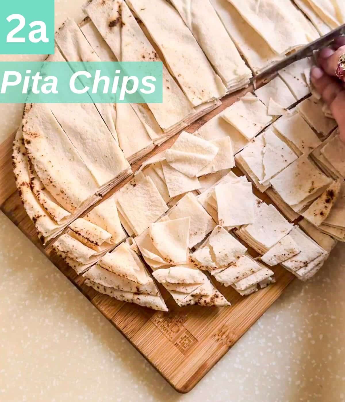 cutting pita chips in square.