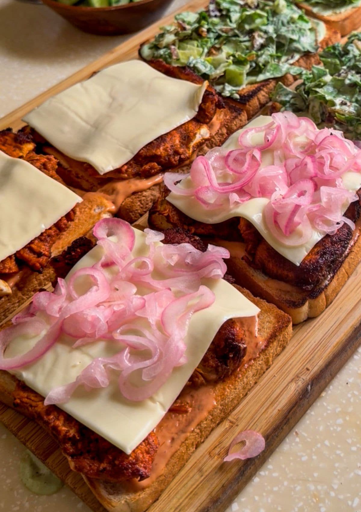 pickled onions on a grilled chicken sandwich.