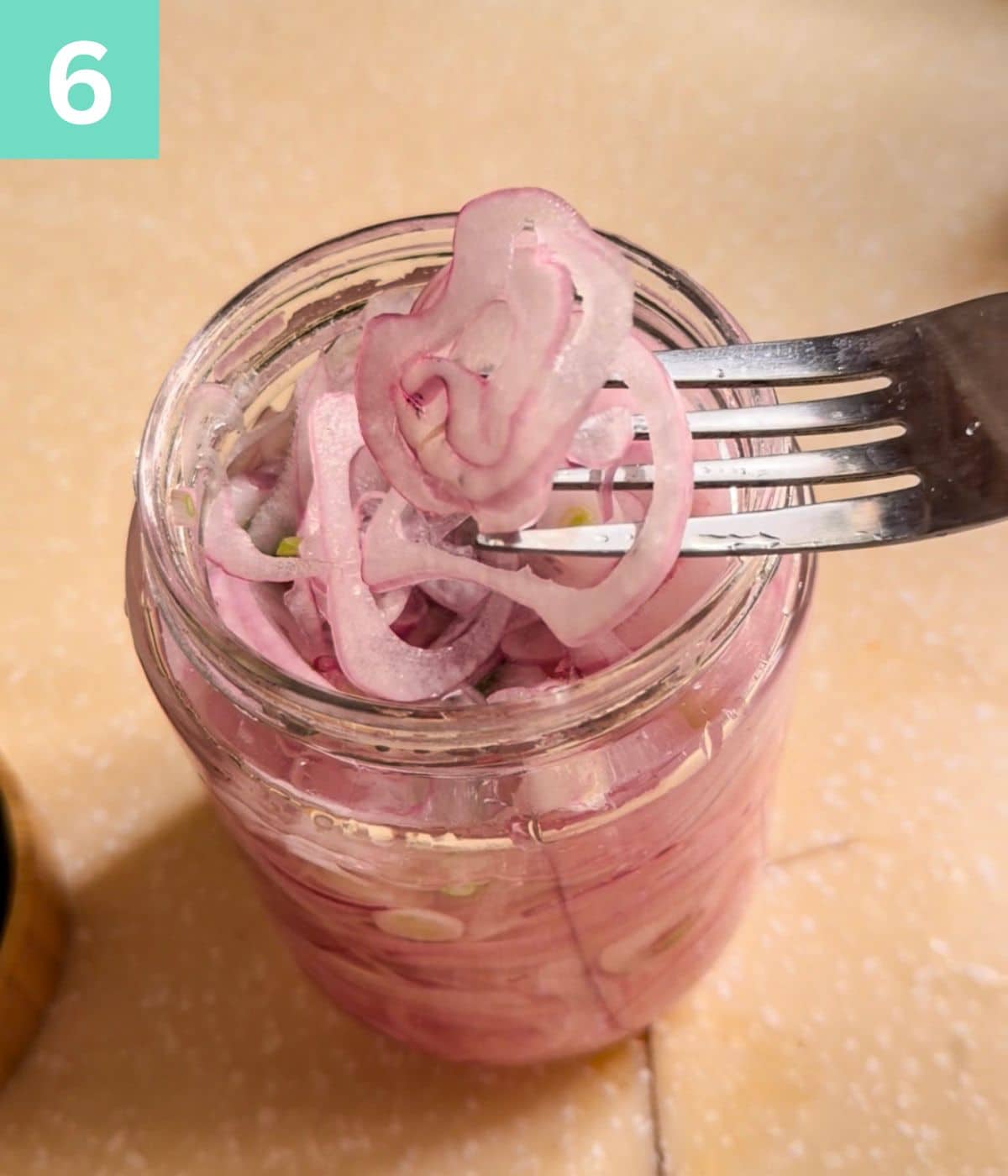 Forking out ready-to-eat pickled onions.